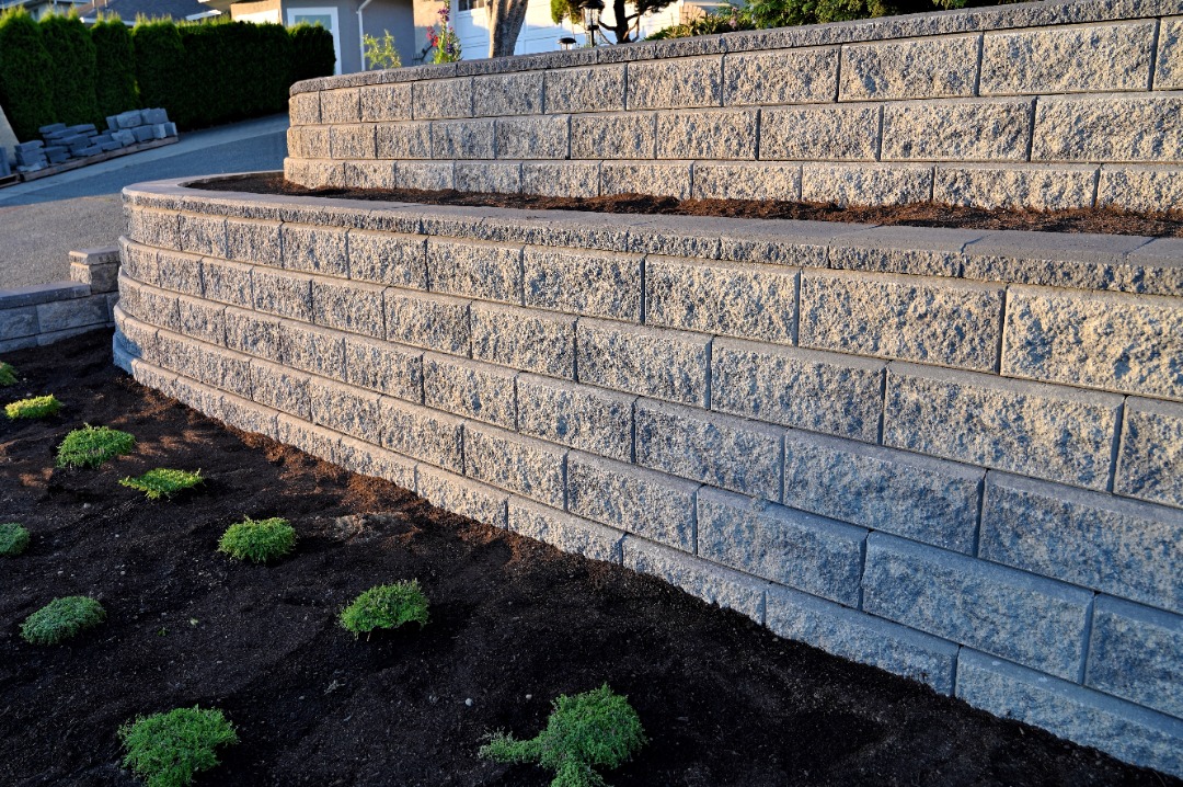 A brand new retaining wall with fresh mulch installed as well.
